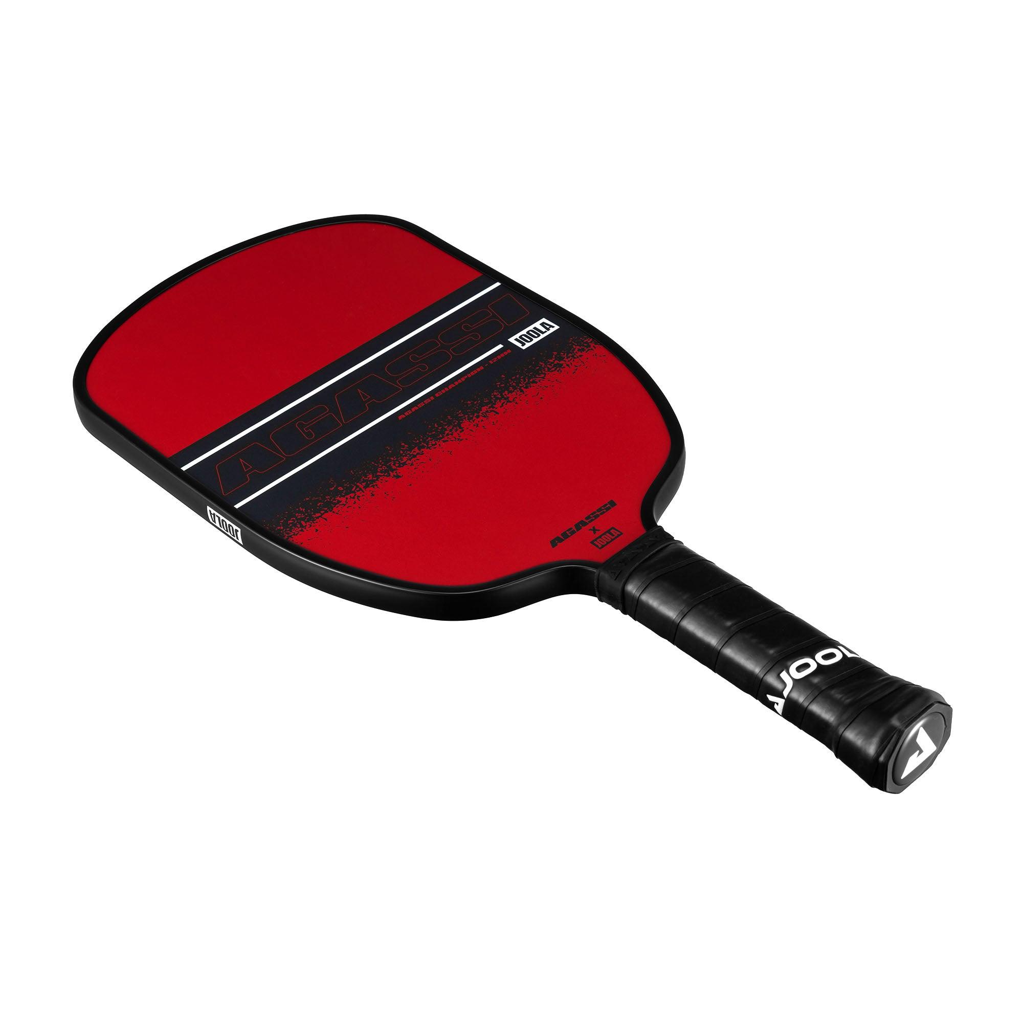 Red Pickleball bat with black handle and "AGASSI" and "JOOLA" lettering.