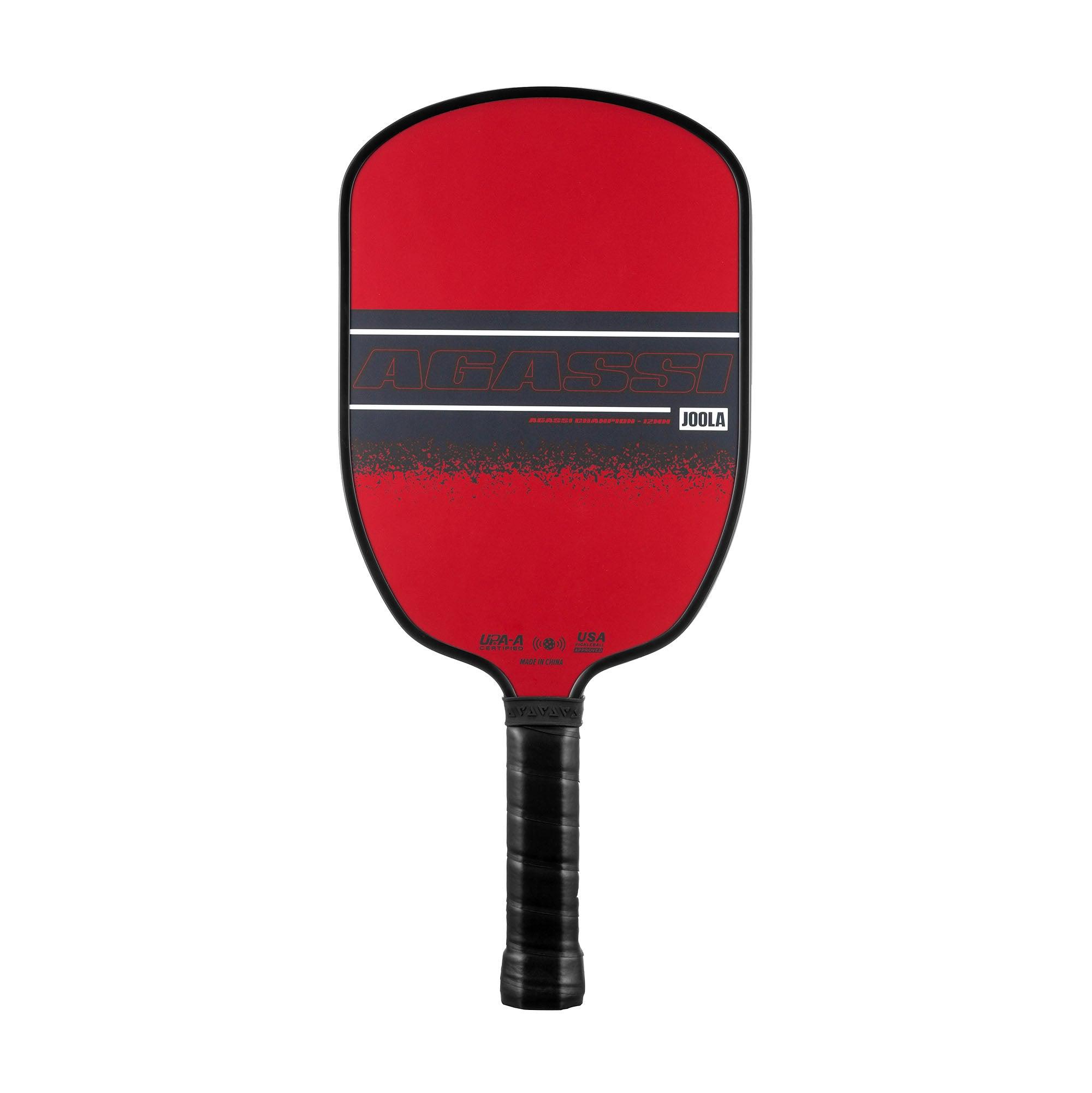 Red Pickleball bat blade with black handle and the inscription AGASSI by JOOLA.